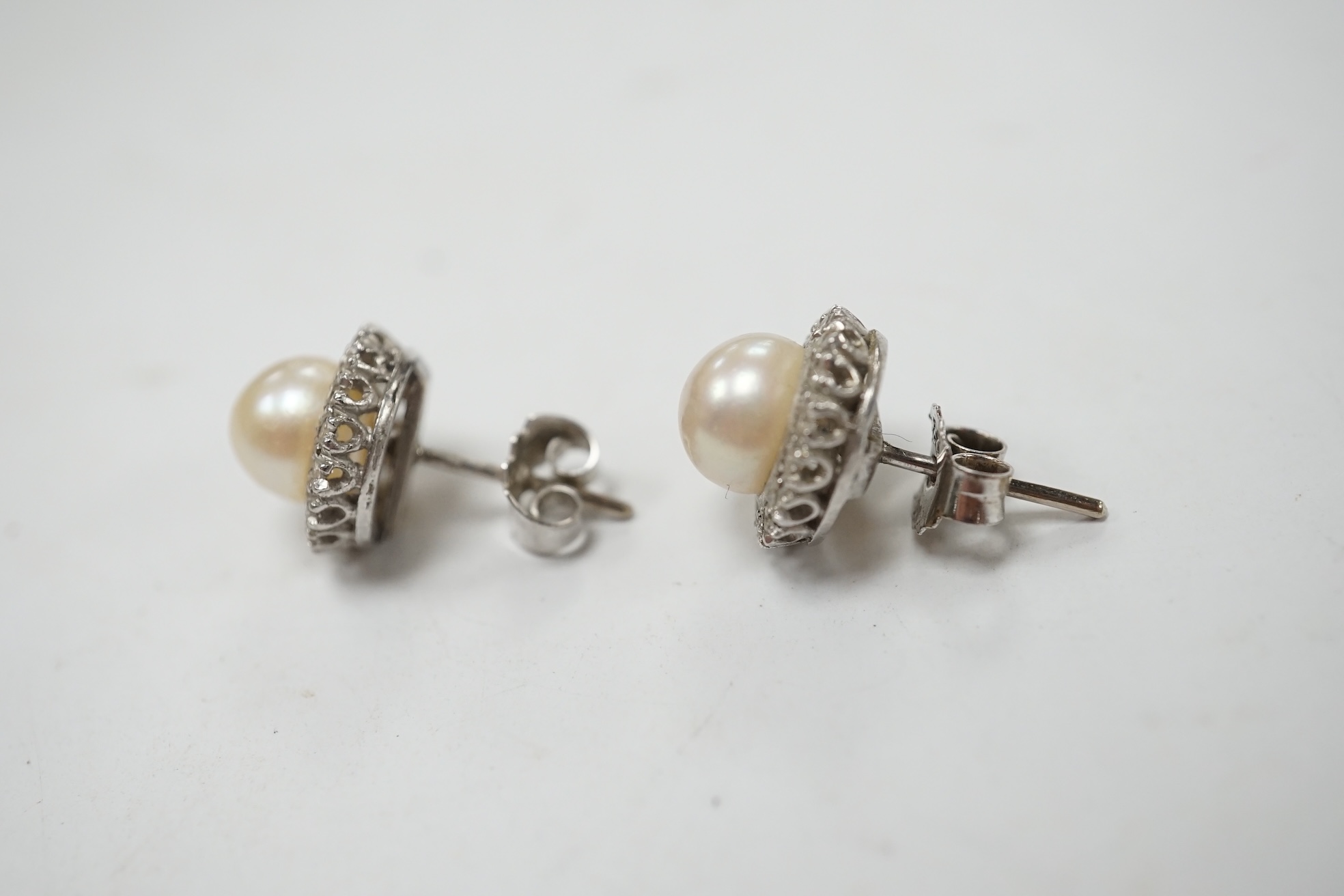 A pair of white metal cultured pearl and diamond cluster set ear studs, 10mm, gross weight 3.6 grams. Condition - fair to good